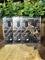 Front side of three Gradey Dick Select rookie basketball cards from Toronto Raptors, card number 90.