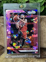 Front view of Fred VanVleet Pink Ice Prizm Parallel card in magnetic protective case showing holographic effects and player image on red Toronto Raptors uniform.
