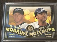 Front of 2008 Upper Deck SP Authentic Marquee Matchups dual baseball card showing Roy Halladay and Derek Jeter images and team names