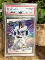 Front view of Shohei Ohtani 2024 Topps Chrome Dodgers Stars of MLB baseball card graded PSA 10 GEM MINT in protective casing.