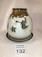 Front view of the fairy light upper piece showing angel and star cut-outs and glaze details.