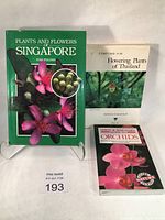 Photo of all three books together: Plants and Flowers of Singapore, Flowering Plants of Thailand, and Guide to Orchids.