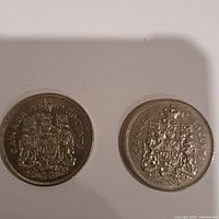 Obverse and reverse sides of the two Canadian 50 cent coins dated 1969 and 1972 showing the Canadian coat of arms.