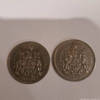 Both coins reverse sides showing the Canadian coat of arms, year and denomination.