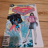 Front cover image of The Man of Steel No. 2 comic showing Superman lifting an object with Lois Lane in front.