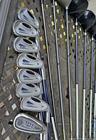 Close-up of irons including Dunlop Powerlift and Ramblet irons with graphite shafts.