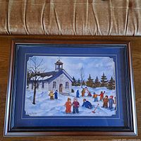 Framed print showing children playing in snow in front of church in winter