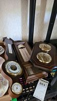 Wood barometers and retro resin thermometer detail showing dials and condition