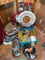 Full view of crates and boxes with assorted nails, screws, ropes, hardware jars, ropes, and tools