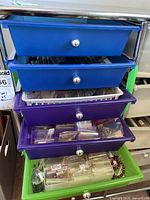 Five-drawer plastic storage unit with blue, purple and green drawers on cart