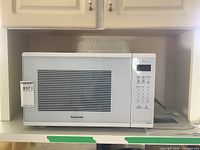 Full frontal view of the Panasonic microwave oven showing the door and control panel.