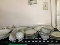 Complete set shown together on shelves and table.