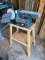 Full view of the Craftsman sander station mounted on a wooden stand showing the belt and disc sander units.