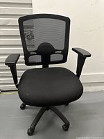 Front view of Alera ergonomic office chair with breathable black mesh back and padded seat showing adjustable armrests and five-point caster base.