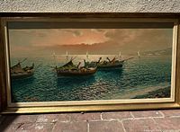 Full view of framed oil painting showing three fishing boats on water with sunset sky and distant shoreline.
