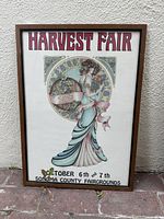 Frontal view of the vintage 1979 Sonoma County Harvest Fair poster featuring a woman in Art Nouveau style, held in a wooden frame.