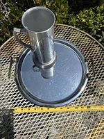 Top view showing the tall silverplate beer stein centered on the 12 inch round silverplate serving tray with handles, displaying the size and shape of both items.