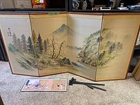Large six-panel Asian themed folding art screen with wooden frame showing mountain and river landscape painting.