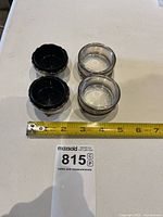Four sterling silver salt cellars shown with glass inserts (2 blue, 2 clear) with a measuring tape indicating size near 2 inches in diameter.