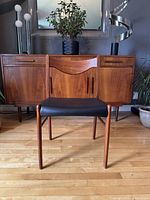 Front view showing chair silhouette against sideboard background