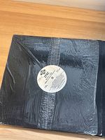 Vinyl record sealed in plastic with white center label featuring 2 Pac text