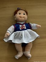 Front view of Ty Beanie Baby Ginger dressed in a cheerleader outfit showing the facial expression and full dress.