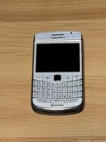 Front view of the White BlackBerry Bold smartphone showing the screen and physical QWERTY keyboard. Device is branded Rogers at the bottom.