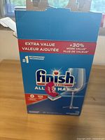 Closed box of Finish All-in-1 Max dishwasher pods with branding and product details visible.