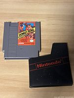 Top view of Donkey Kong Classics NES cartridge with label and black Nintendo branded dust sleeve.