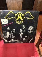 Front cover of Aerosmith Get Your Wings LP showing band members and logo with price sticker