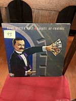 Front cover of Blue Oyster Cult Agents of Fortune LP showing a man in a tuxedo holding tarot cards in front of a vault door.