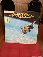 Front cover of Boston Third Stage album with spaceship over Earth and 'Boston' logo.