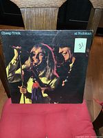 Front cover of Cheap Trick At Budokan vinyl album showing band members performing on stage.