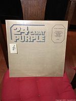 Front cover of Deep Purple 24 Carat Purple album showing gold embossed lettering and minor wear.