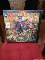 Front cover of Elton John Captain Fantastic vinyl LP featuring colorful illustrated artwork.