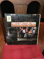 Front cover of the vinyl LP showing the album title and artwork featuring an old street scene with a man and woman.