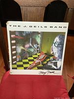 Front cover of The J. Geils Band Freeze Frame album showing the surreal artwork and some corner wear on the sleeve.