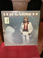 Front cover of Leif Garrett vintage LP album, showing the artist in white suit with visible wear on jacket.