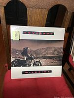 Front cover of sealed Loverboy Wildside LP showing biker on motorcycle with mountain background, shrink wrapped.