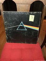 Front cover of vintage LP album showing prism and rainbow light beam design with signs of wear and scratches.