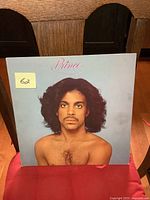Front cover of the Prince self titled LP album showing Prince's portrait with bare chest and long hair.