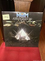 Front cover of Prism Armageddon LP featuring a glowing crystal prism pyramid with city lights in background.