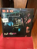 Front cover of 'Hi Infidelity' showing artwork with two people, one smoking and cityscape at night