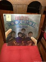 Front cover of The Beatles Rock N Roll Music double LP vinyl album showing colorful embossed lettering and portraits.