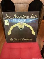 Front cover of The Boomtown Rats album The Fine Art of Surfacing displaying artwork of a swimmer without a head underwater.