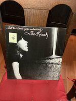 Front cover of The Knack '...But The Little Girls Understand' vinyl album showing a young woman looking upward in black and white.