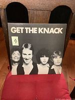 Front cover of The Knack Get the Knack vinyl LP album showing the four band members' heads against a black background with white text