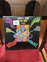 Front cover of The Who Happy Jack vinyl LP showing colorful psychedelic artwork and band name.