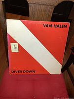 Front cover of the Van Halen Diver Down album showing red background with white diagonal stripe and black text.