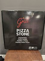 Front of the packaging showing brand 'Hans Grill' and 'Pizza Stone' label